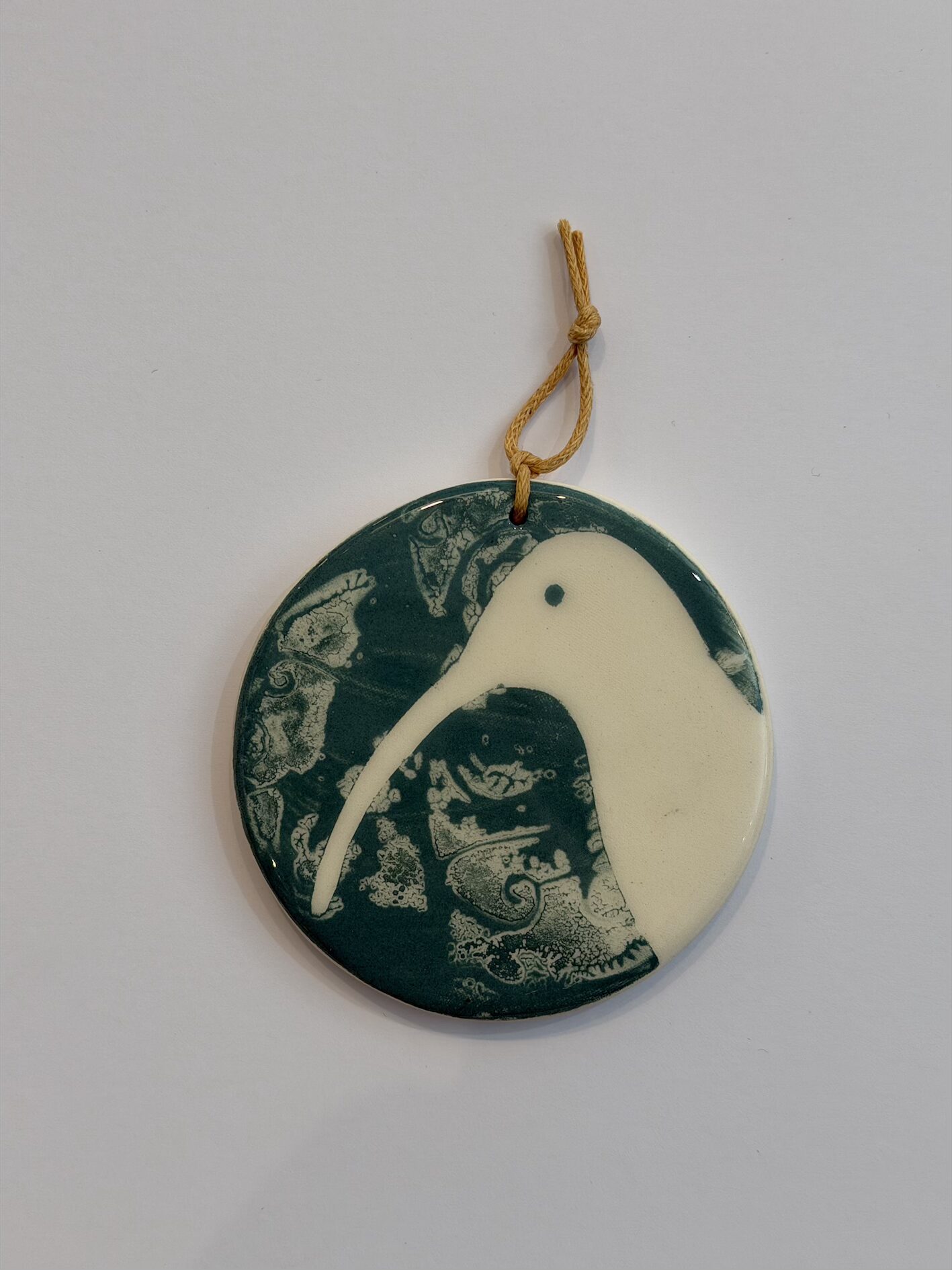 Ceramic Hanging Decoration of Curlew on Teal Patterned Background